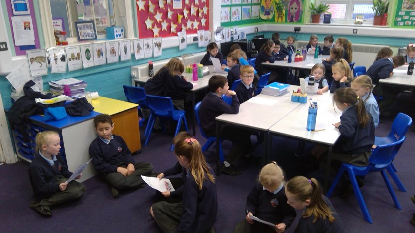 Image of Year 4 having Year 1's reports read to them